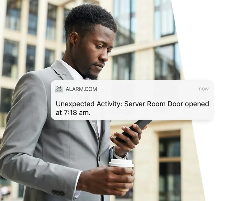 Business owner getting an Alarm.com activity alert on his phone