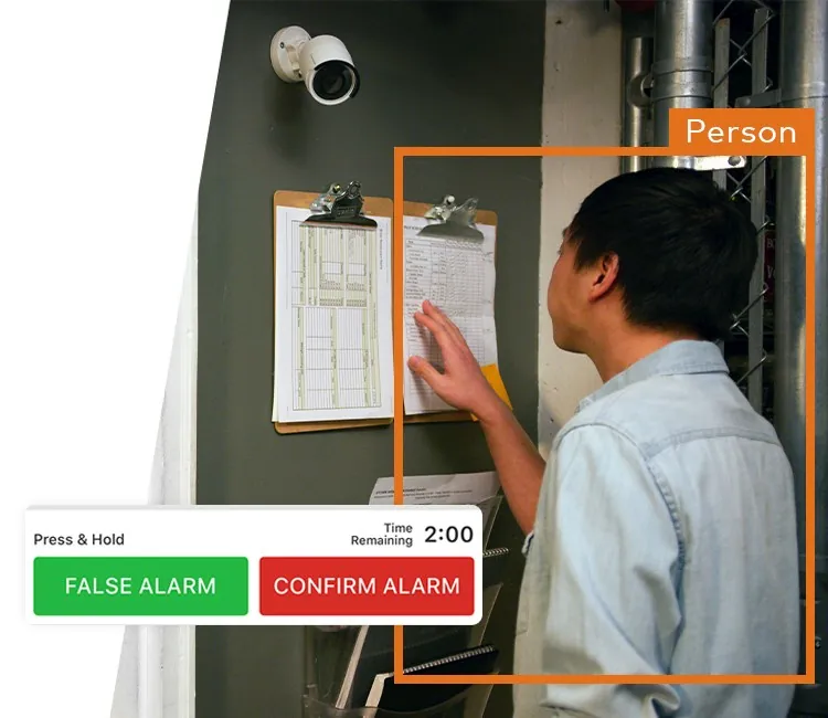 Phone showing cancel or confirm alarm buttons over camera footage